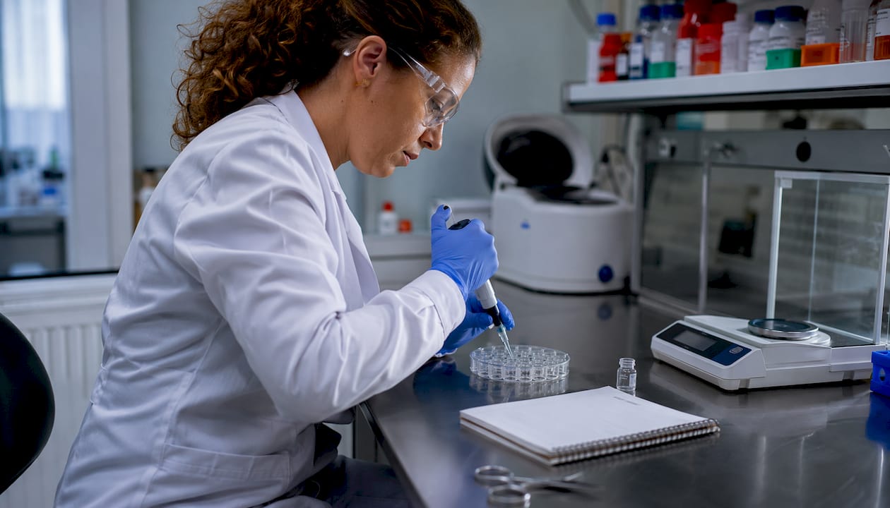Scientist pipetting peptides in research lab