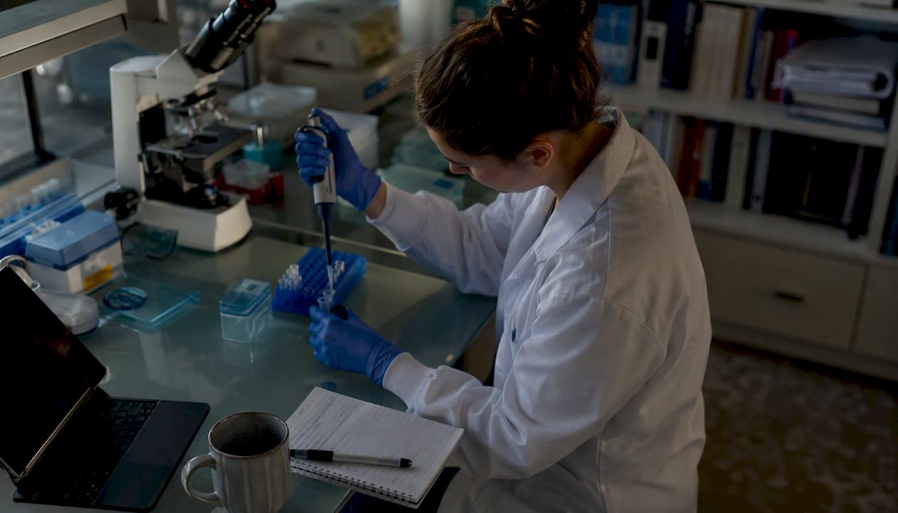 Researcher pipetting in biolab