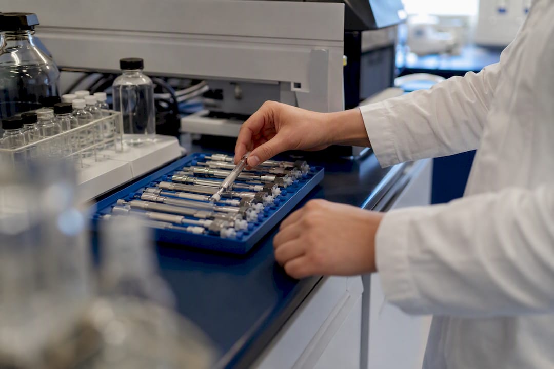 Scientist adjusting LC-MS peptide chromatography column